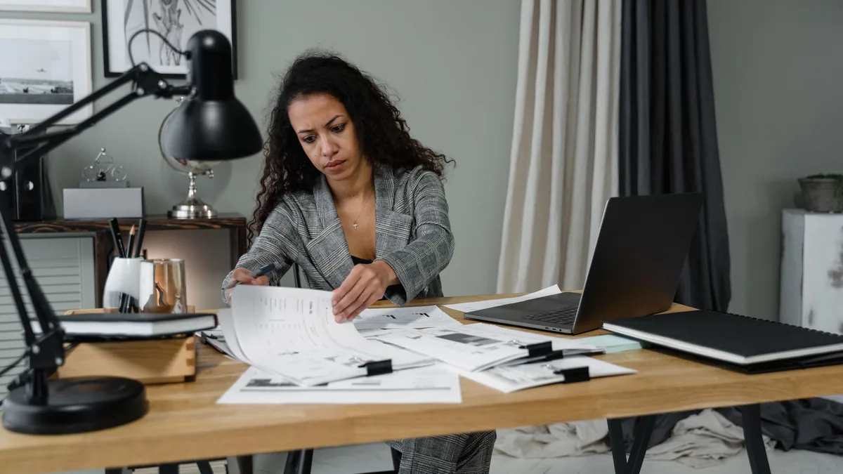 Business owner reviewing documents and plans at a desk