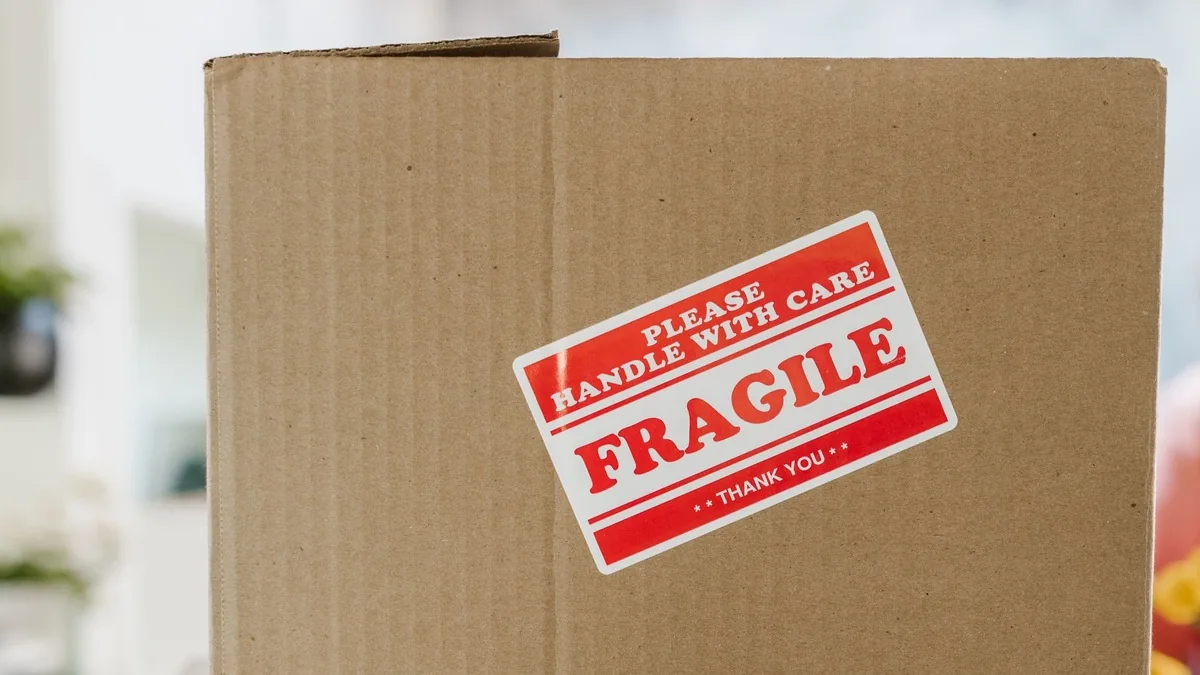 Cardboard shipping box with a fragile sticker, ready for an online order